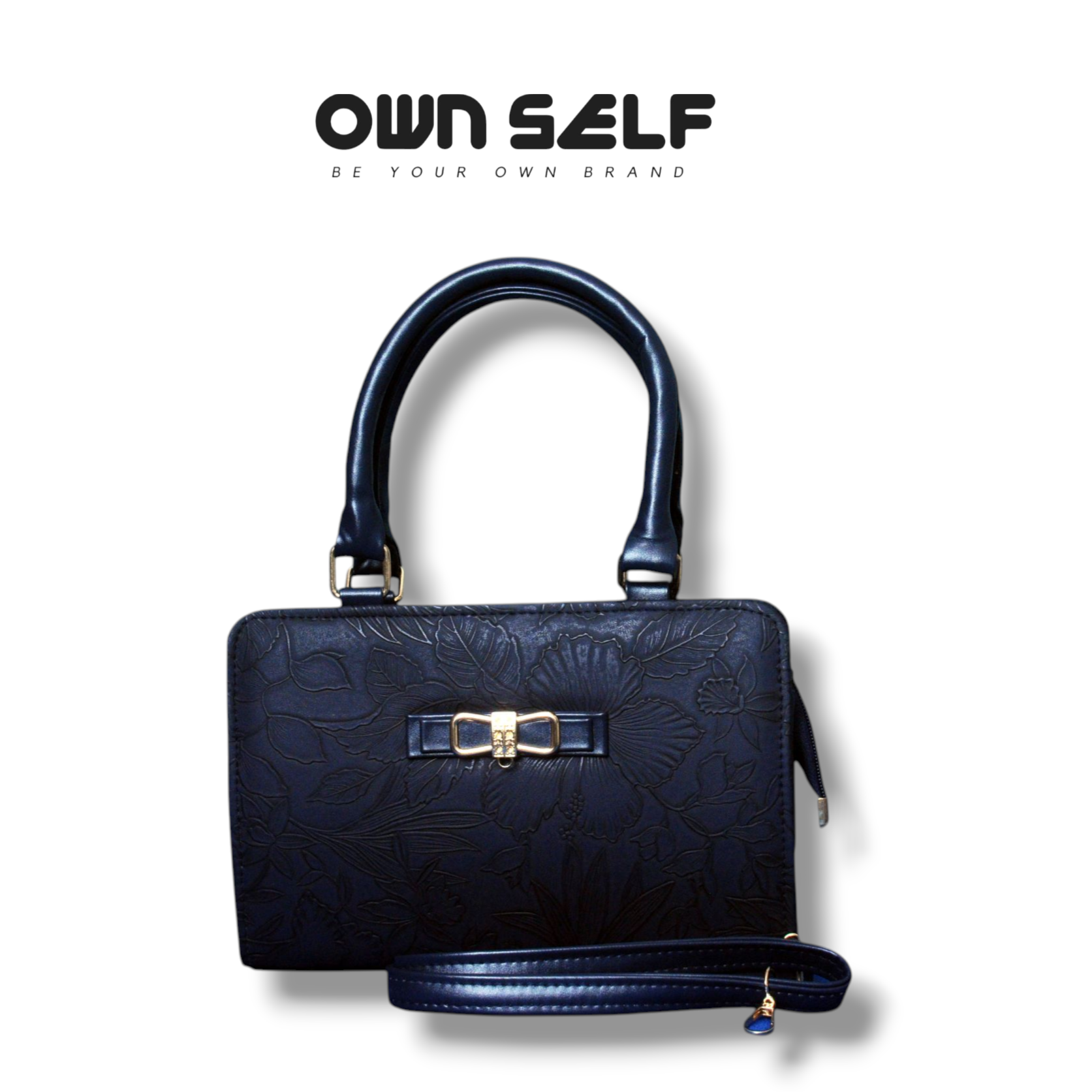 Black handbag with gold accents on a white background, featuring 'OWN SELF' branding.